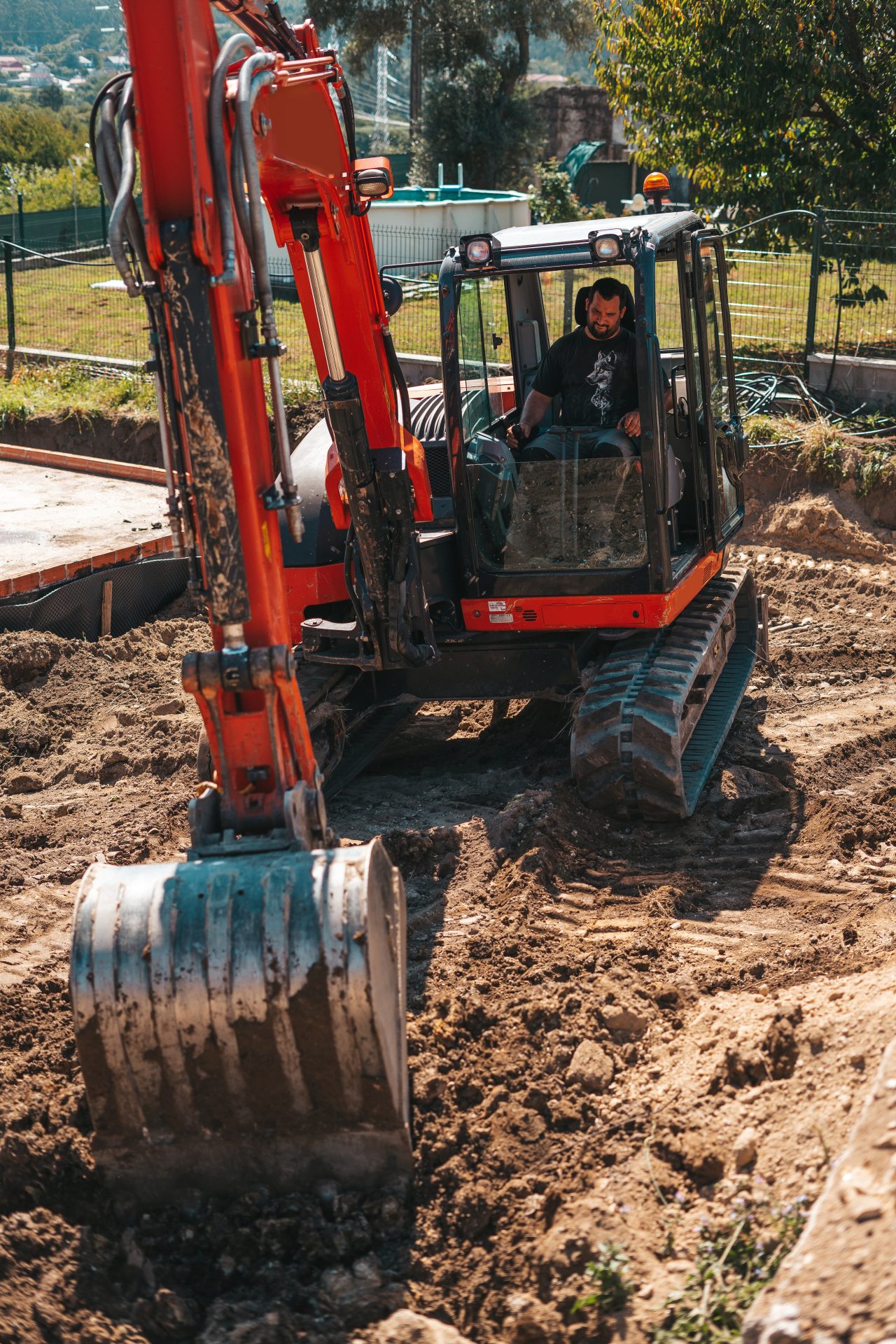 worker-driving-an-excavator-on-a-construction-site-2021-09-04-09-41-38-utc